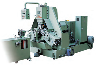 Large green Dong Il 3-die rolling machine with three angled rolling heads at the center and a coolant tank on the left