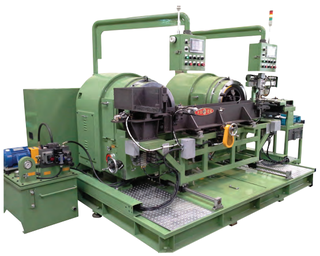 Green horizontal 3-die automatic rolling machine with two large drum units, overhead control arms and a loading conveyor