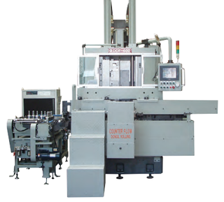 Dong Il DCF-600 counter-flow rolling machine with a loading unit on the left and touchscreen control